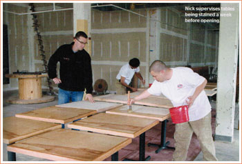 Nick supervises tables being stained a week before opening..