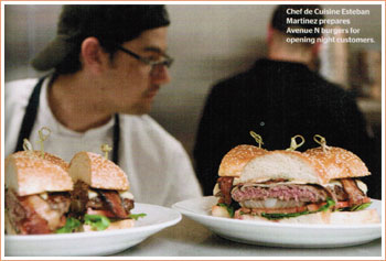 Chef de Cuisine Esteban Martinez prepares Avenue N burger for opening night customers.